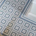 Blue and white geometric patterned porcelain floor tiles with a repeating diamond design from adventuras ziggy corner blue