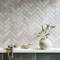Aegean Pink Herringbone Marble Mosaic pink marble herringbone mosaic styled with an off-white ceramic vase