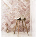 Aegean pink marble tile 7.5 x 30.5cm with rustic wooden stool featuring round seat and weathered texture