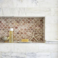 Aegean Pink Scallop Marble Mosaic pink marble scallop mosaic on a marble shelf styled with a spa bottle