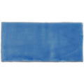 A rectangular blue ceramic agapanthus half tile wall tile with a smooth glazed surface and subtle shade variations