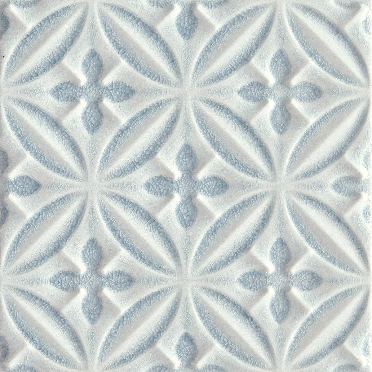 Alhambra blue decor glazed tile featuring white and light blue textured repeating geometric flower patterns