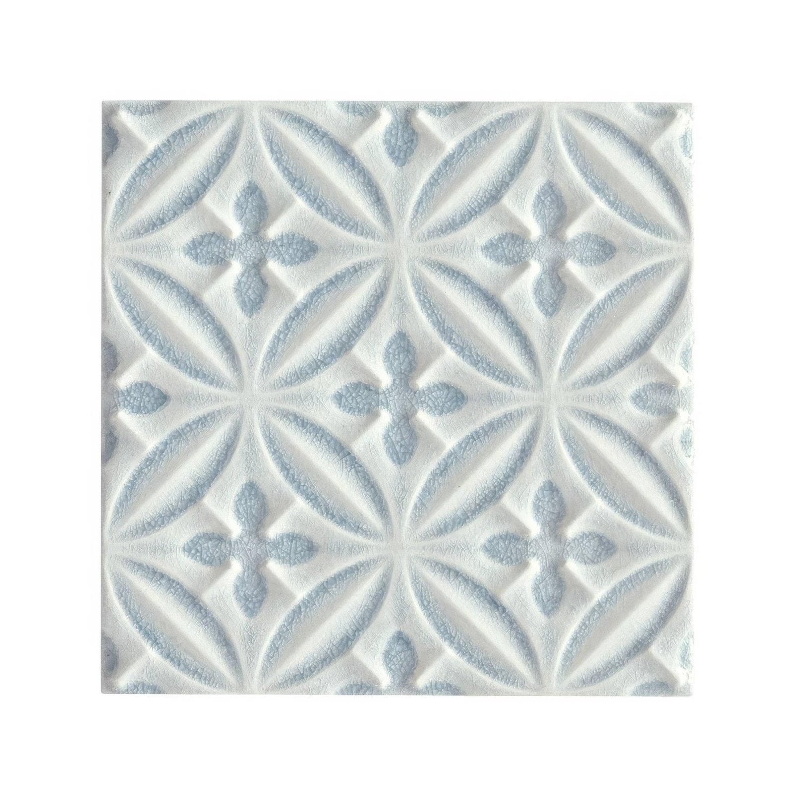 White ceramic glazed tile with subtle light blue embossed floral pattern alhambra blue decor design