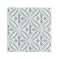 White ceramic glazed tile with subtle light blue embossed floral pattern alhambra blue decor design