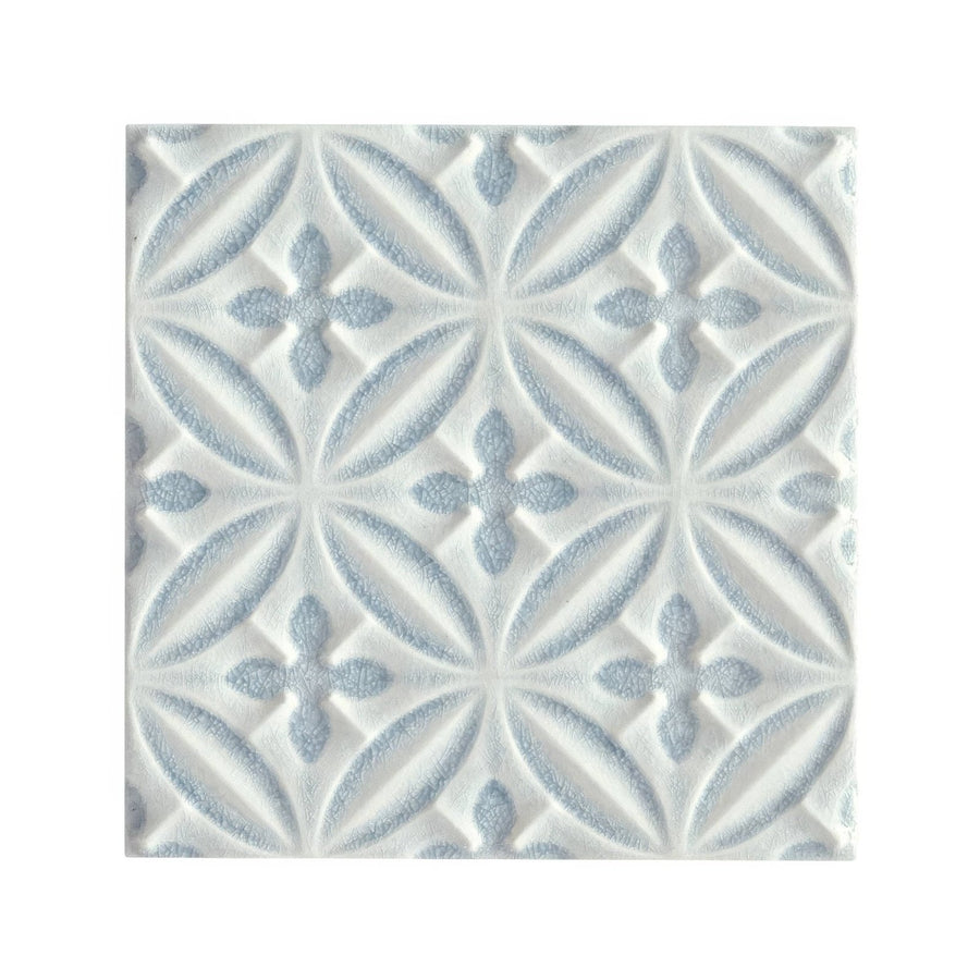 White ceramic glazed tile with subtle light blue embossed floral pattern alhambra blue decor design