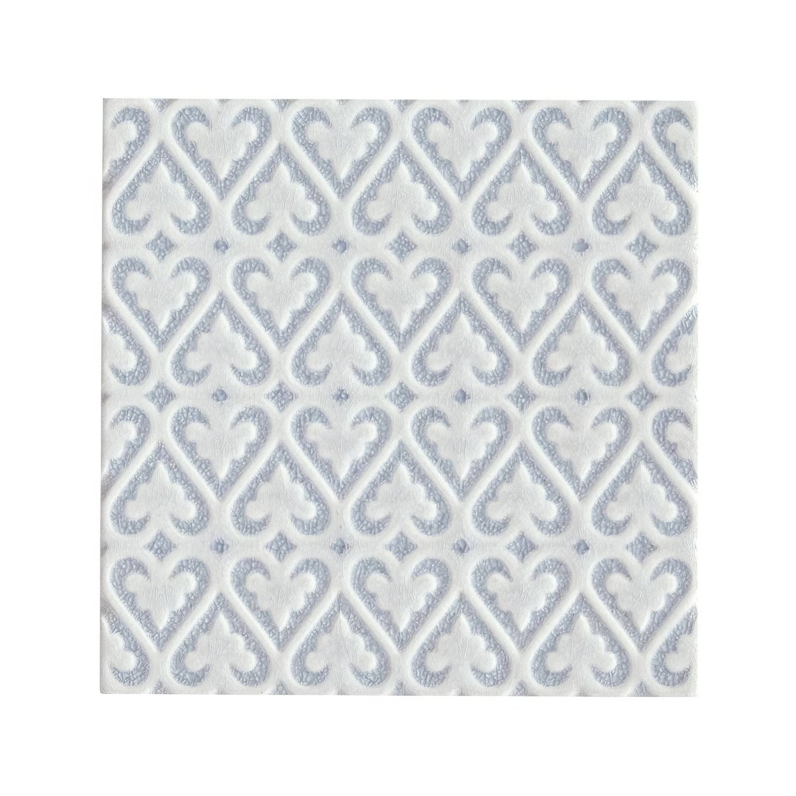 White paper napkin with subtle silver embossed damask pattern complementing alhambra blue decor glazed tile