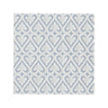 White paper napkin with subtle silver embossed damask pattern complementing alhambra blue decor glazed tile