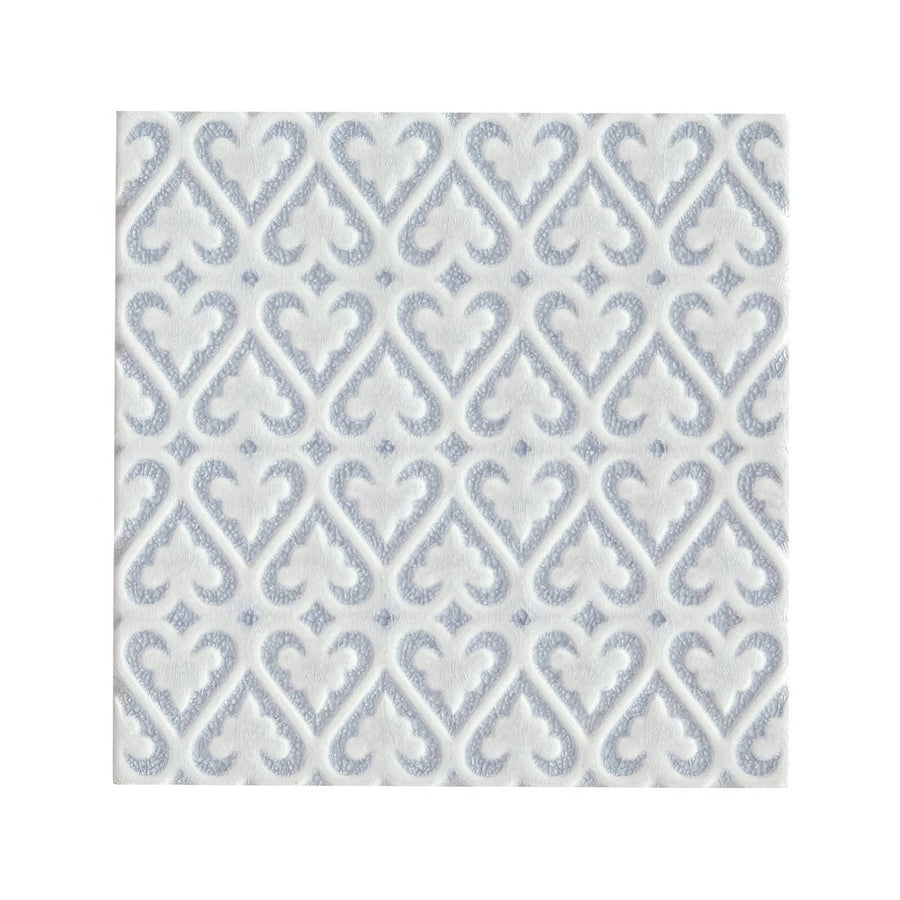 White paper napkin with subtle silver embossed damask pattern complementing alhambra blue decor glazed tile
