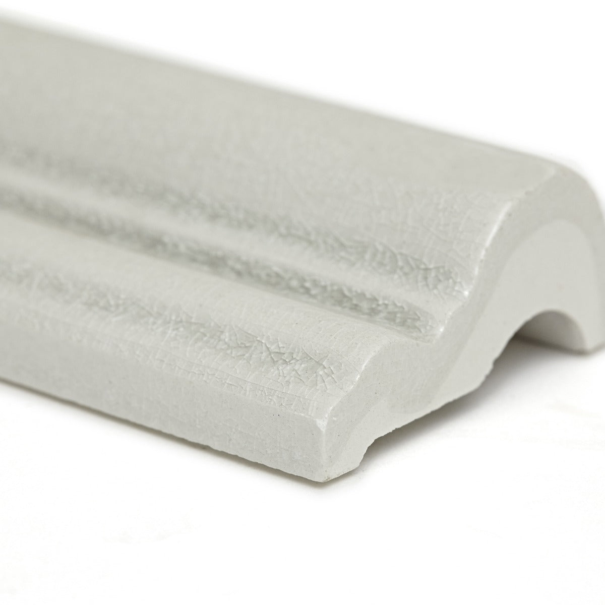 White textured ceramic crown molding with glossy finish and subtle ridged detailing from alhambra grey glazed dado 5 x 15cm