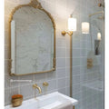 Gold-framed ornate mirror with arched top and decorative scrollwork in alhambra grey decor 2 glazed tile design