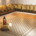 Alhambra Summer Yellow and Regency Bath on White patterned porcelain tiles styled with gold satin pillows on built-in seating
