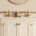 Gold-toned ornate bathroom faucet with white ceramic handles on alphonse mucha evening reverie quarter tile county white