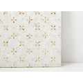 Alpine Golden Promise white and gold mosaic tile panel with small four-petaled mother-of-pearl flower inlays