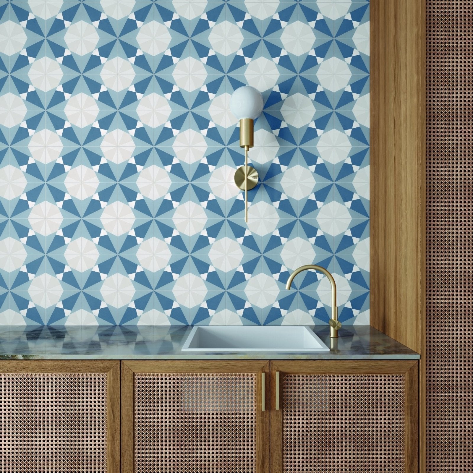The altea blue taco features a sleek white ceramic rectangular sink with a polished brass faucet on a dark marble countertop