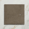 A square dark gray amaya limestone tumbled cabochon with natural veining and slightly rough texture