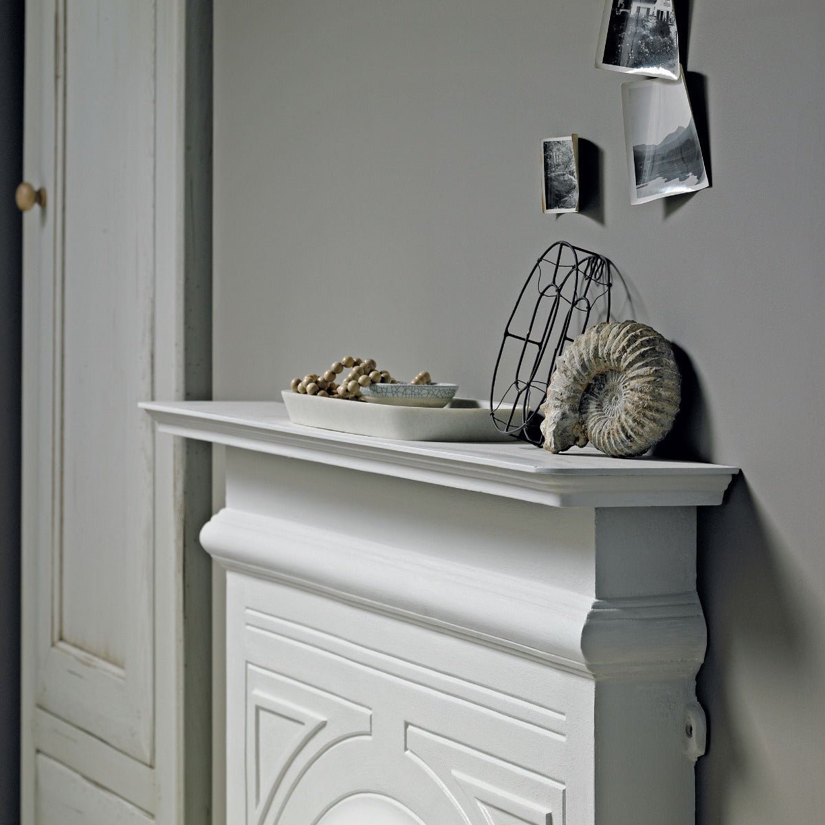 White painted fireplace mantel amber gris with decorative molding and scalloped edge for elegant home decor