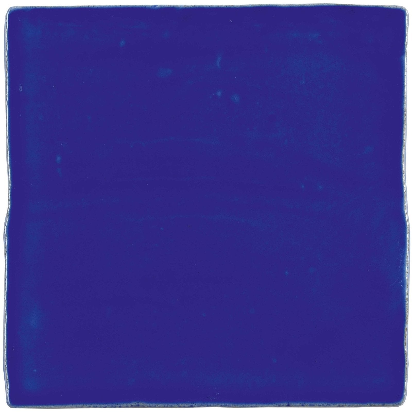Amun field tile is a square ceramic tile with a rich glossy cobalt blue glaze and slightly uneven edges