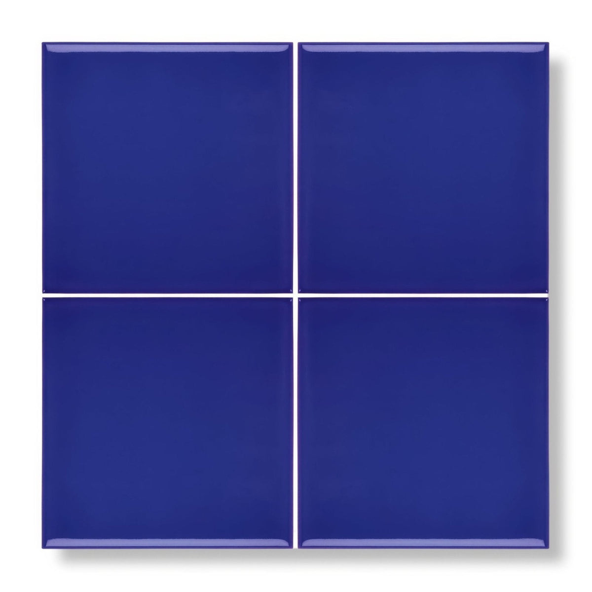Four glossy royal blue square ceramic tiles arranged in a grid from the andalucia blue glazed tile collection