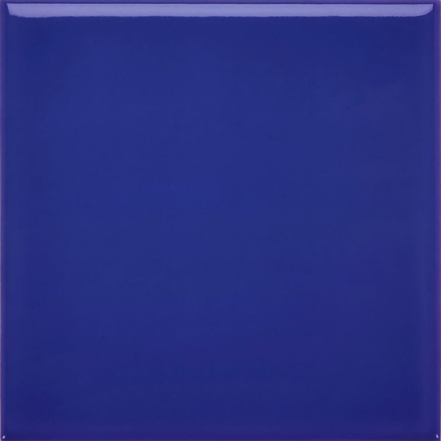 A glossy royal blue glazed square tile with a smooth reflective surface from the andalucia blue collection