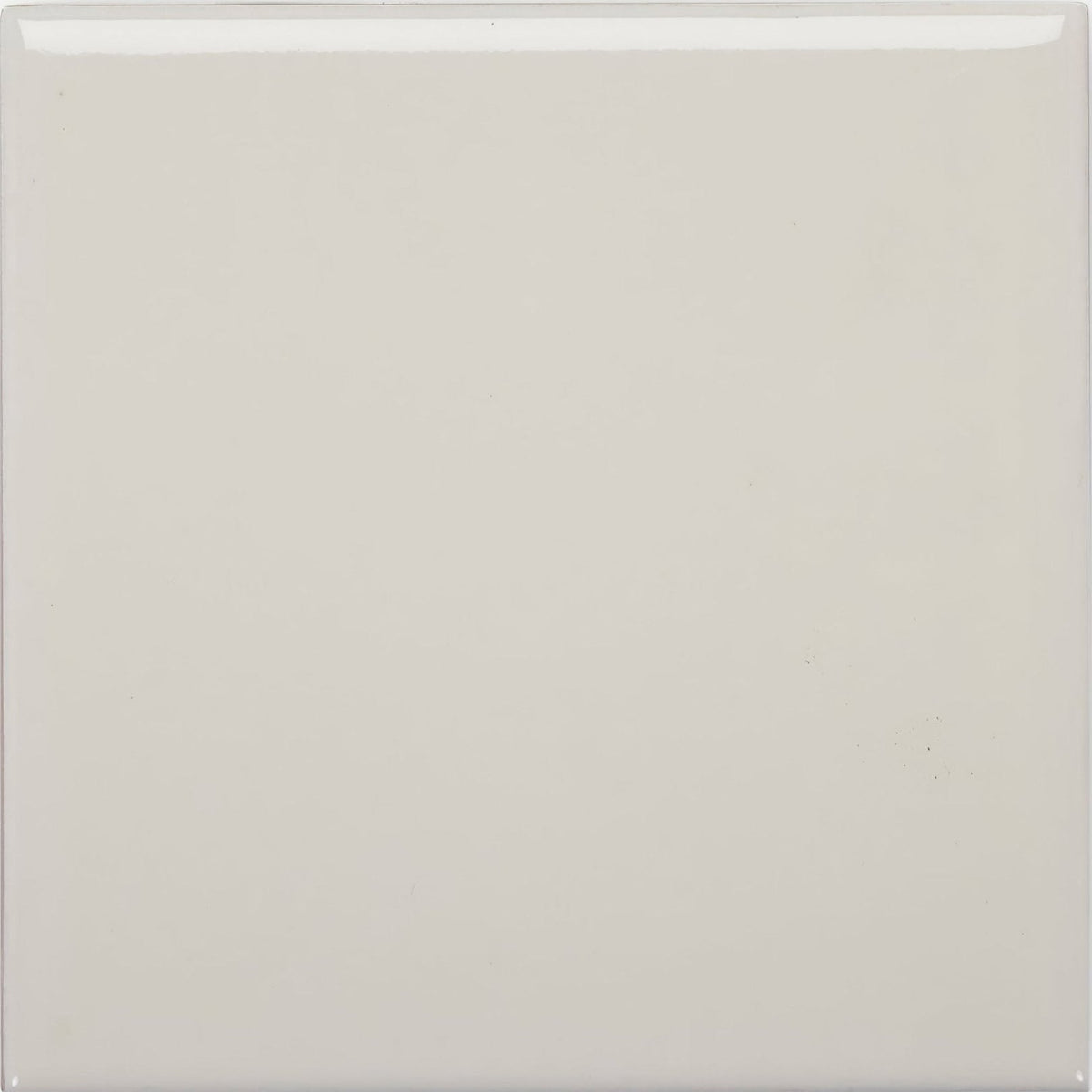 A smooth square ceramic tile in glossy off-white finish called andalucia cream glazed tile