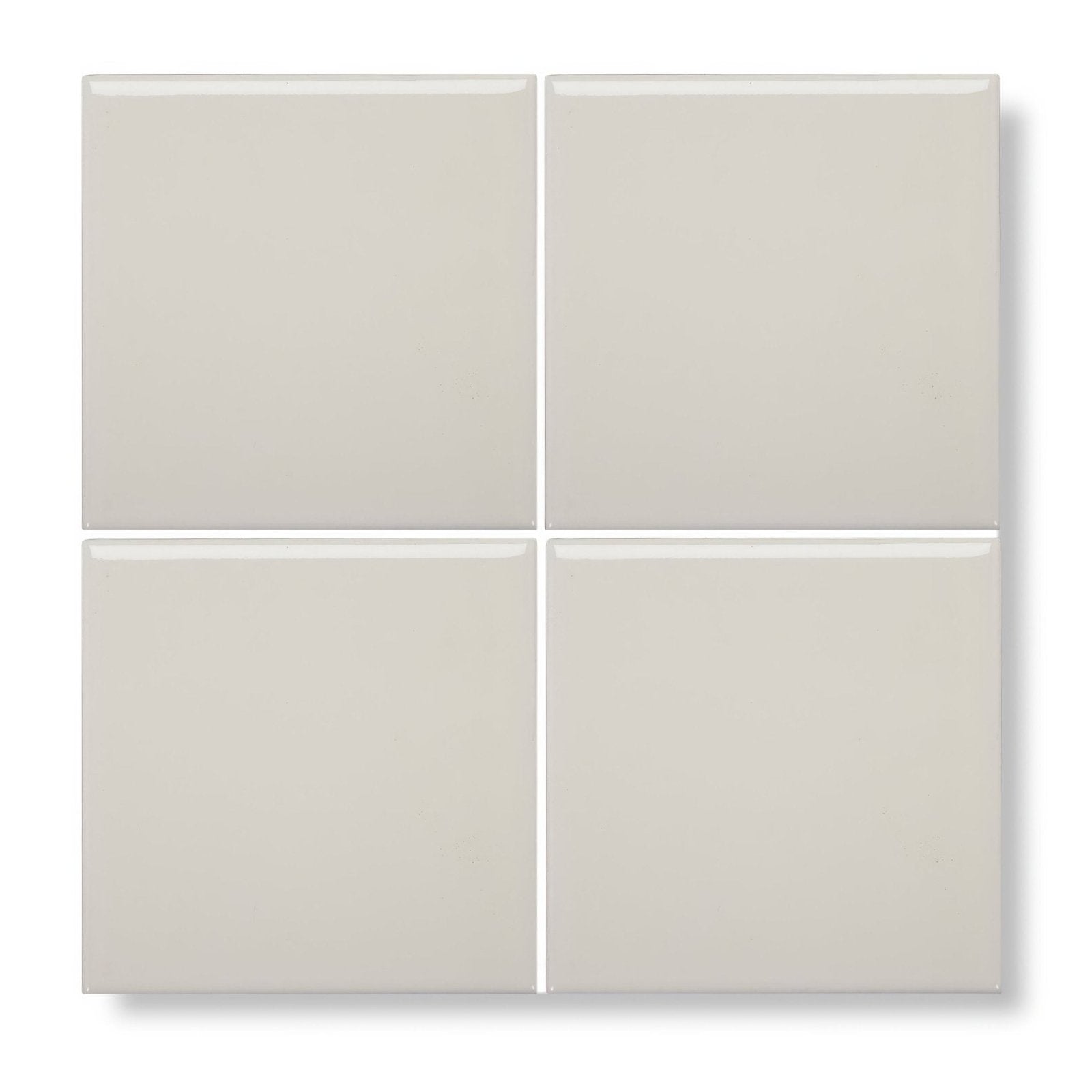 Four square glossy off-white ceramic tiles arranged in a grid from andalucia cream glazed tile collection
