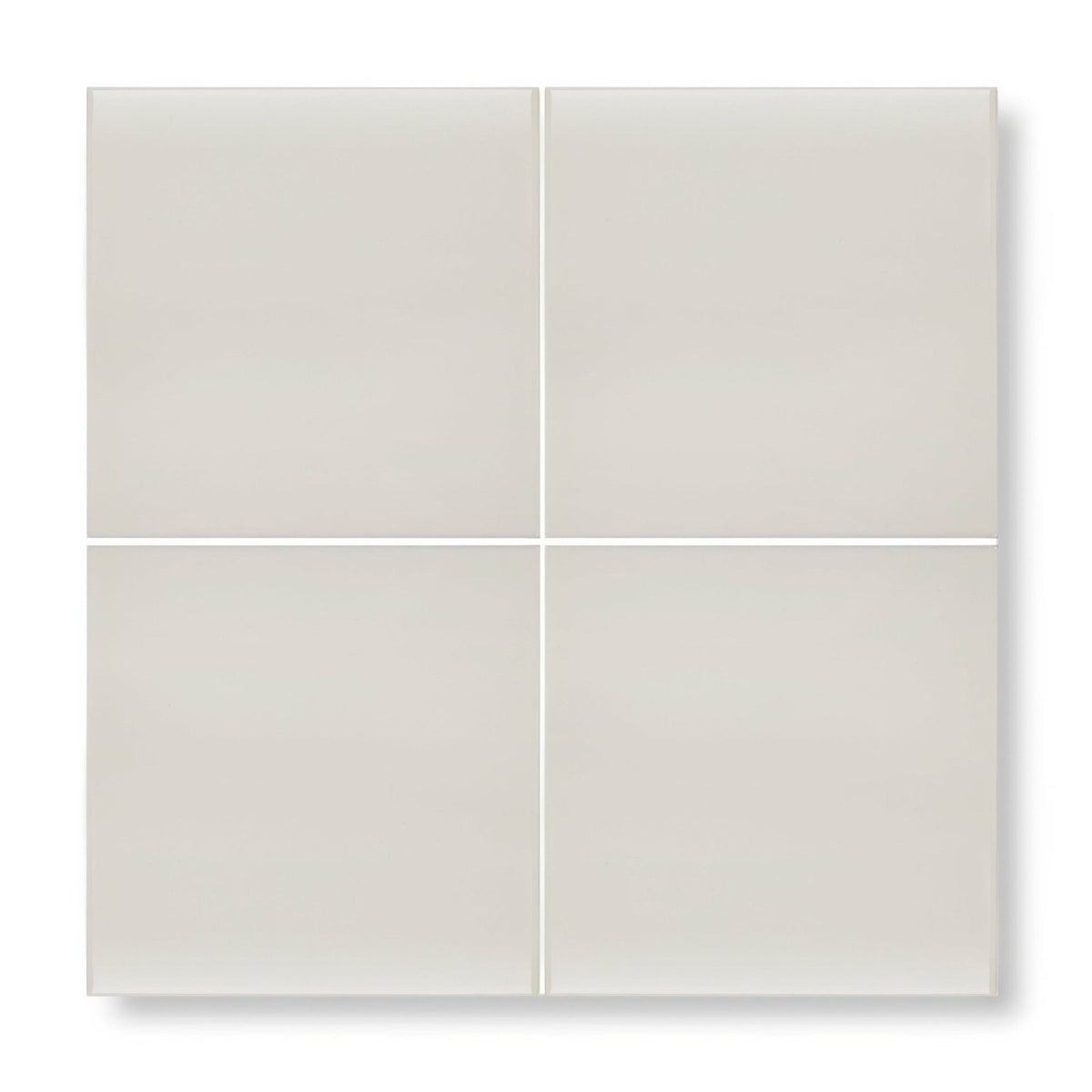Four square matte-finished beige ceramic tiles arranged in a grid featuring andalucia cream glazed tile 20cm