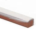 A rectangular ceramic whetstone with a smooth cream glazed white top and textured brown base called andalucia cream glazed pencil