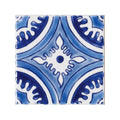 Blue and white ceramic tile with intricate symmetrical floral patterns from andalucia hacienda collection
