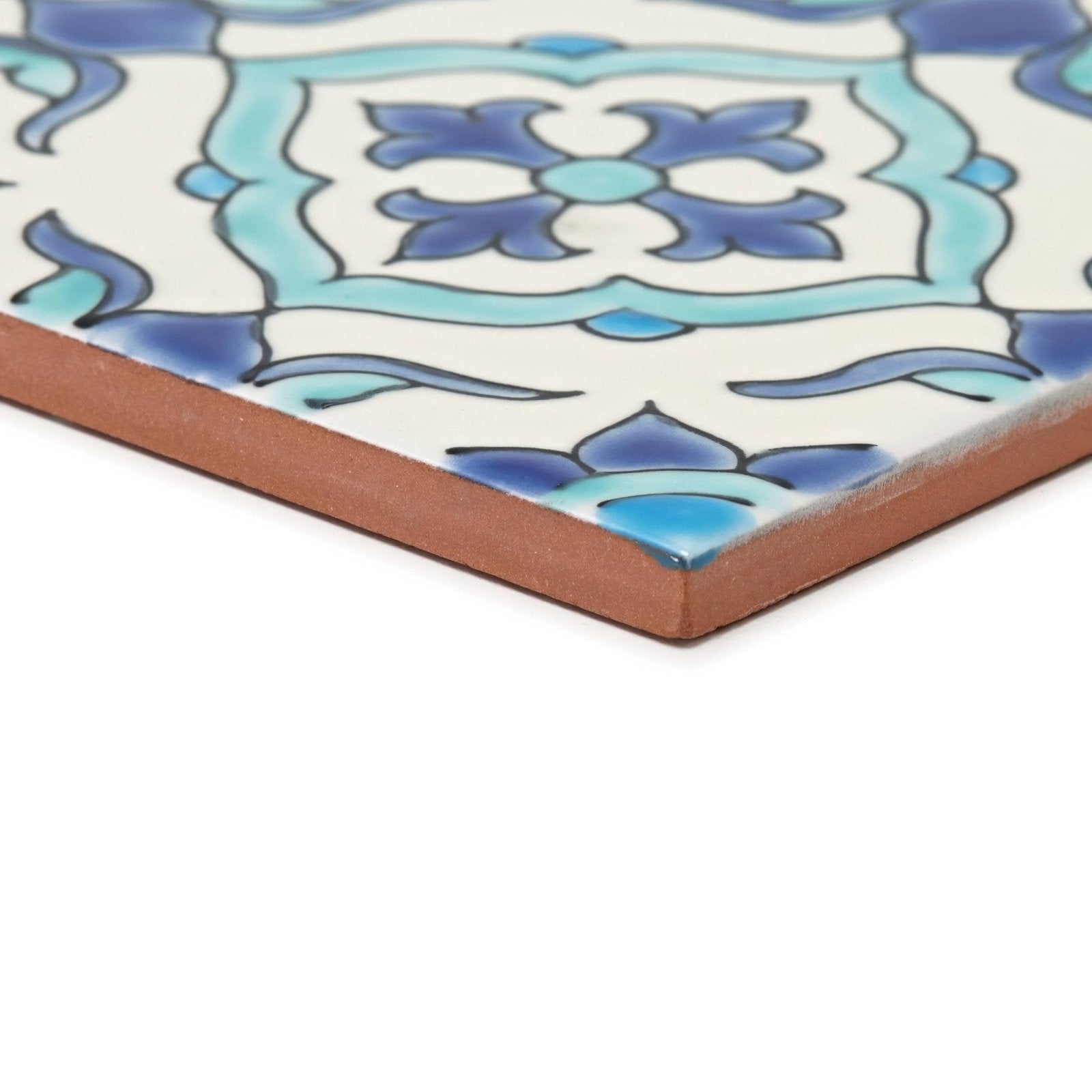 Square ceramic tile with white surface blue turquoise floral pattern and unglazed terracotta edge andalucia morena 20x20