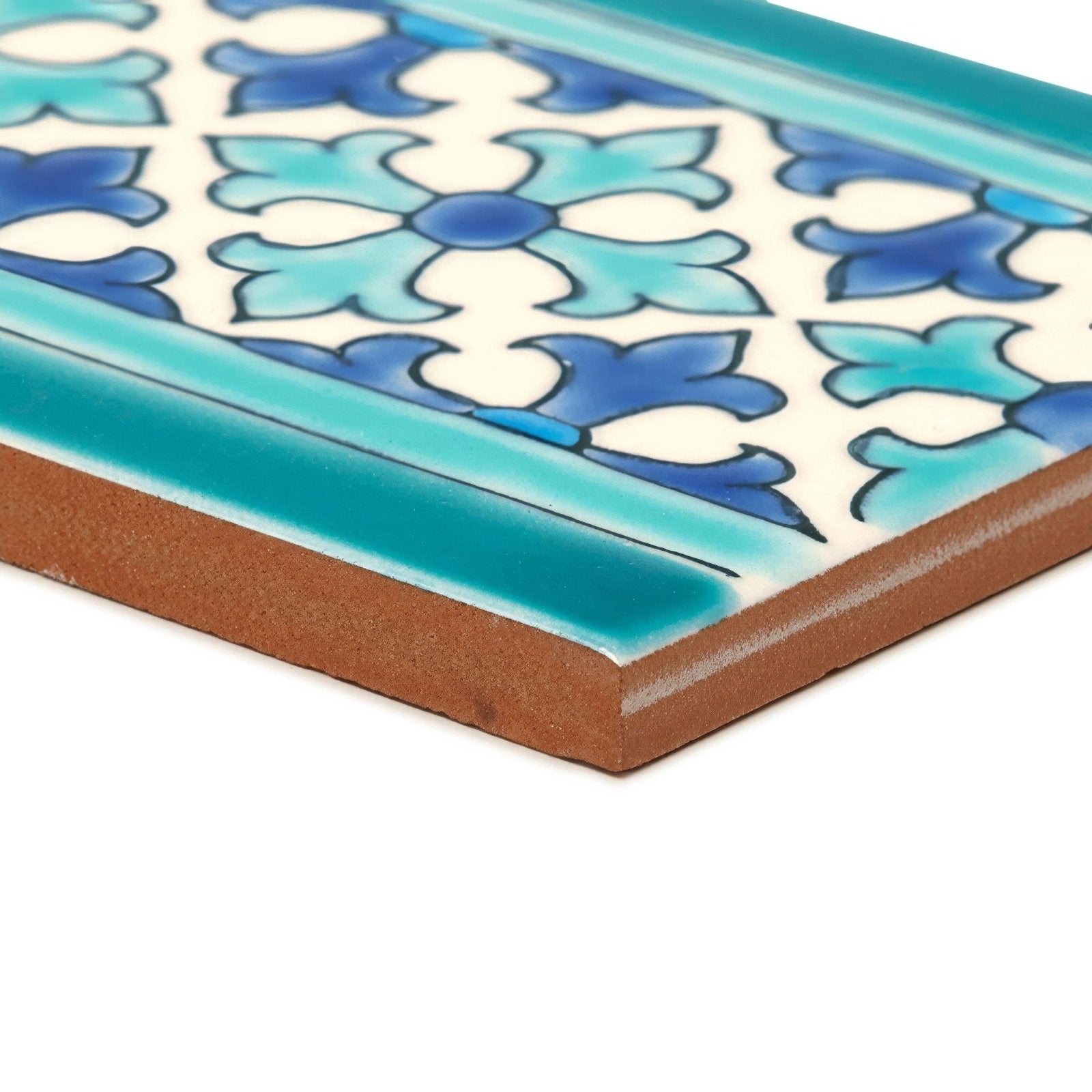 A rectangular ceramic tile with blue and white floral pattern and teal border from andalucia morena patterned border collection