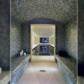 Anthracite 25mm square dark blue mosaic tiles in a luxurious arched steam room with purple star-like lights
