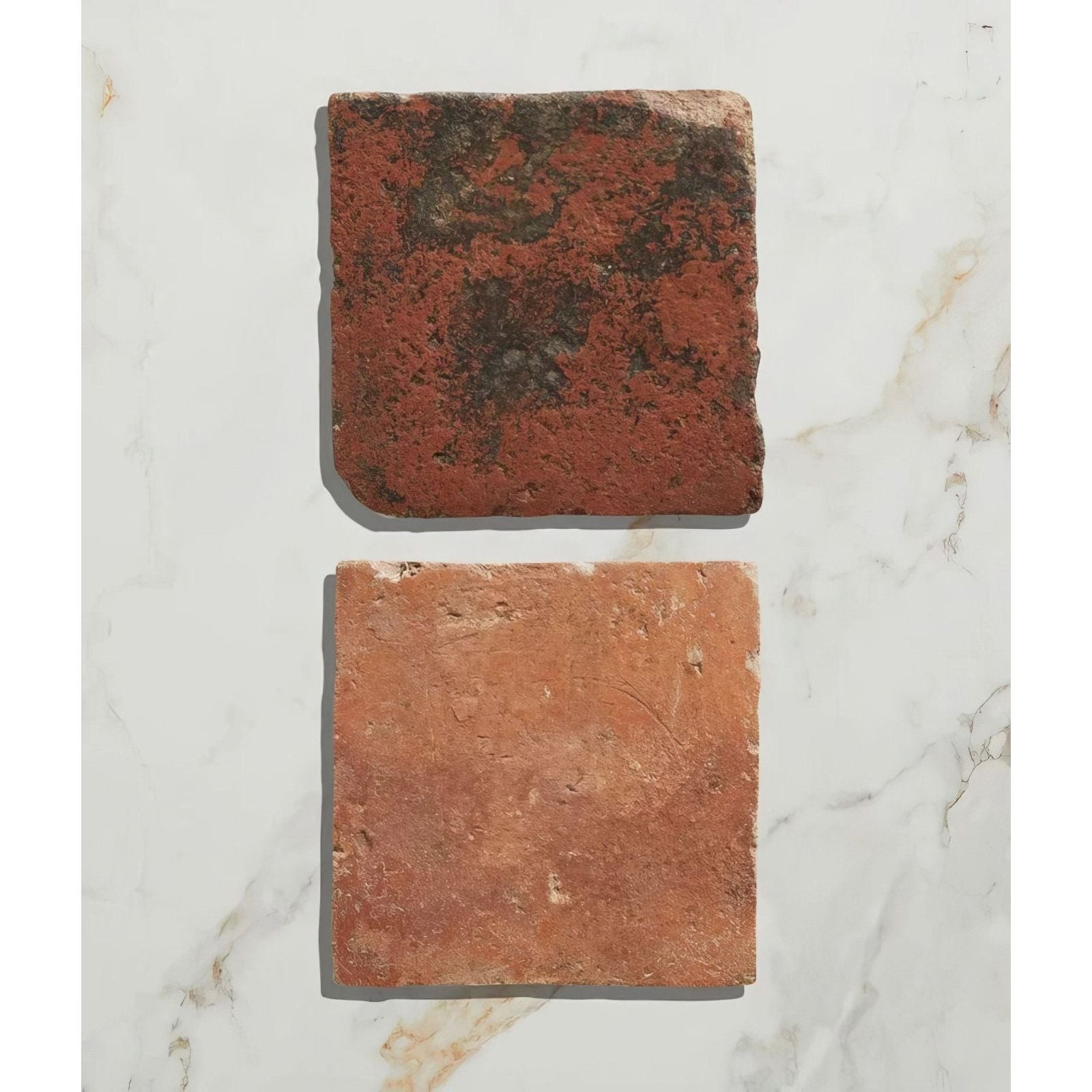 Two rustic red clay tiles with weathered textures and natural imperfections from antique burgundy terracotta reclaimed