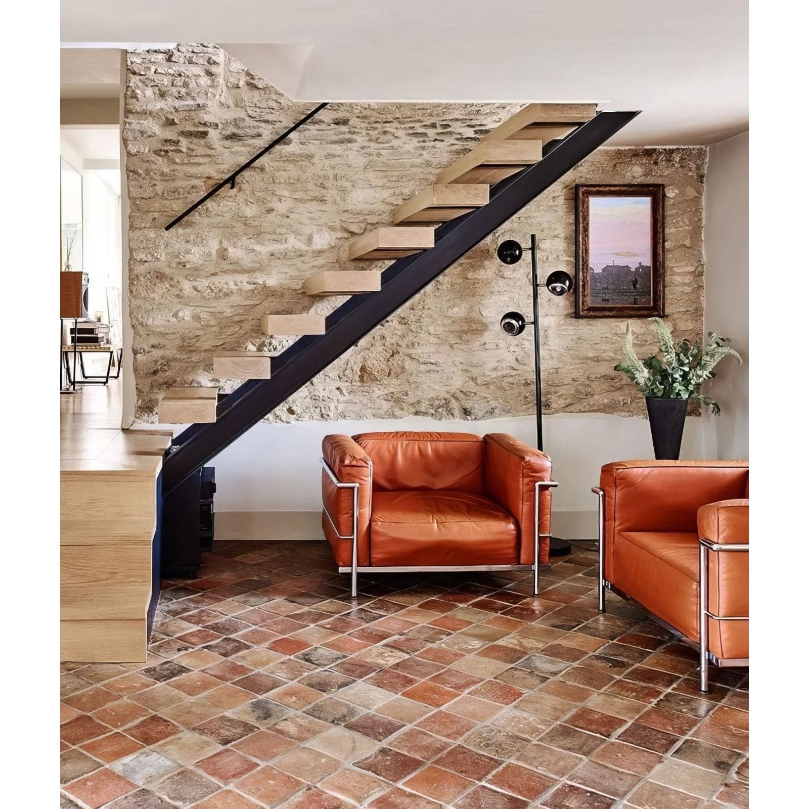 Orange leather armchairs with chrome metal frames in antique burgundy terracotta reclaimed style