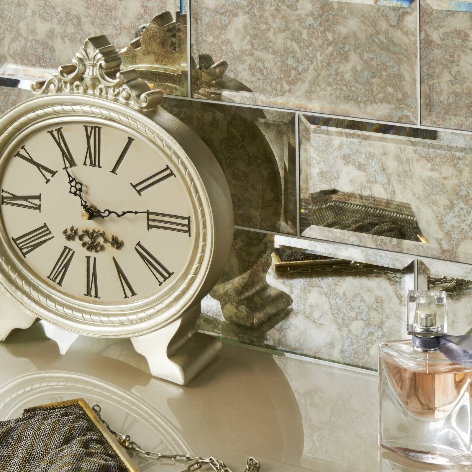 Antique mirror bevel silver clock with roman numerals and ornate detailing in an antique style design