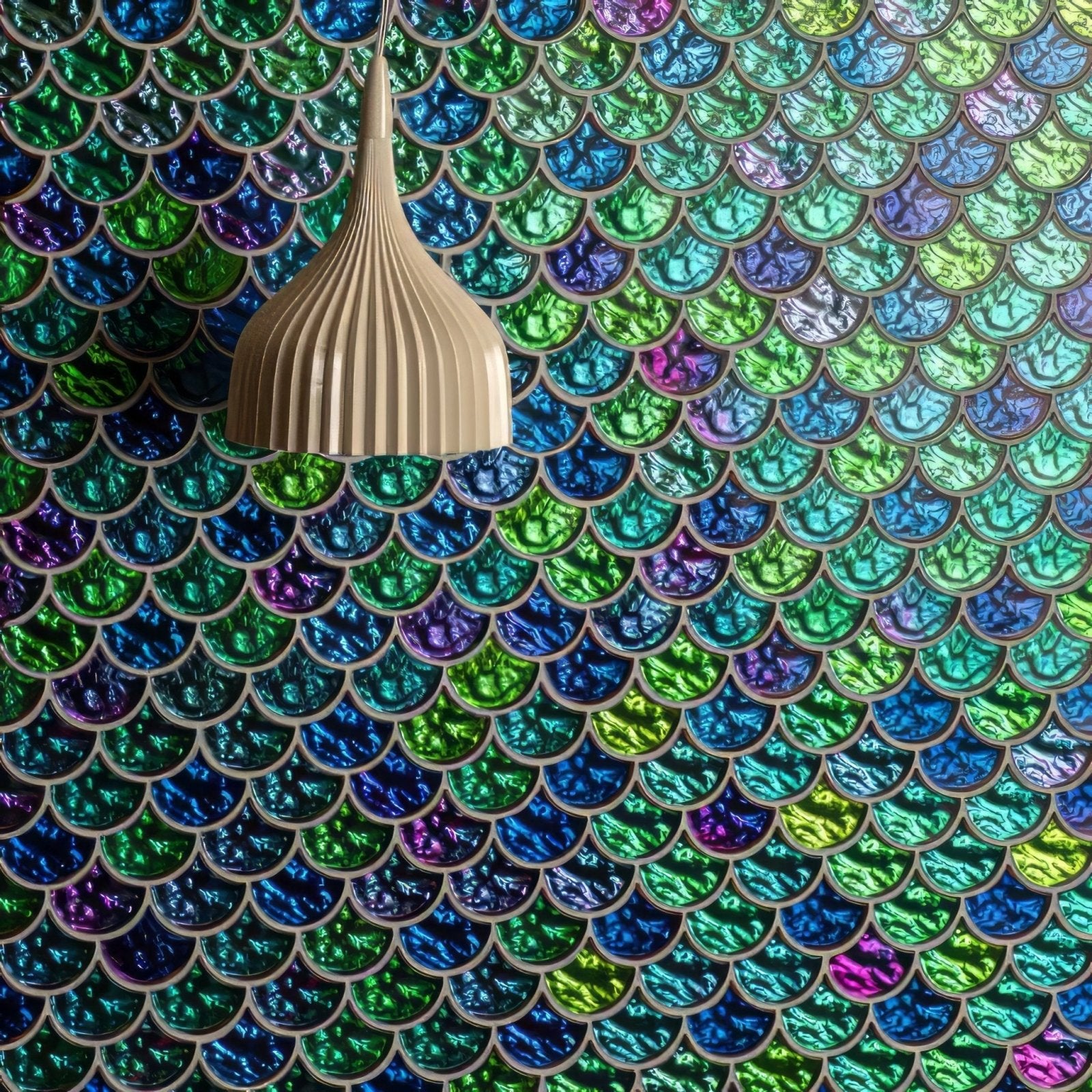 Beige ribbed pendant light hanging above iridescent aqua scale clear mosaic tiles with scale pattern