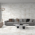 Aquarius Onyx Grey 60 x 120cm white and grey marble-effect tiles with a grey sectional sofa and coffee table