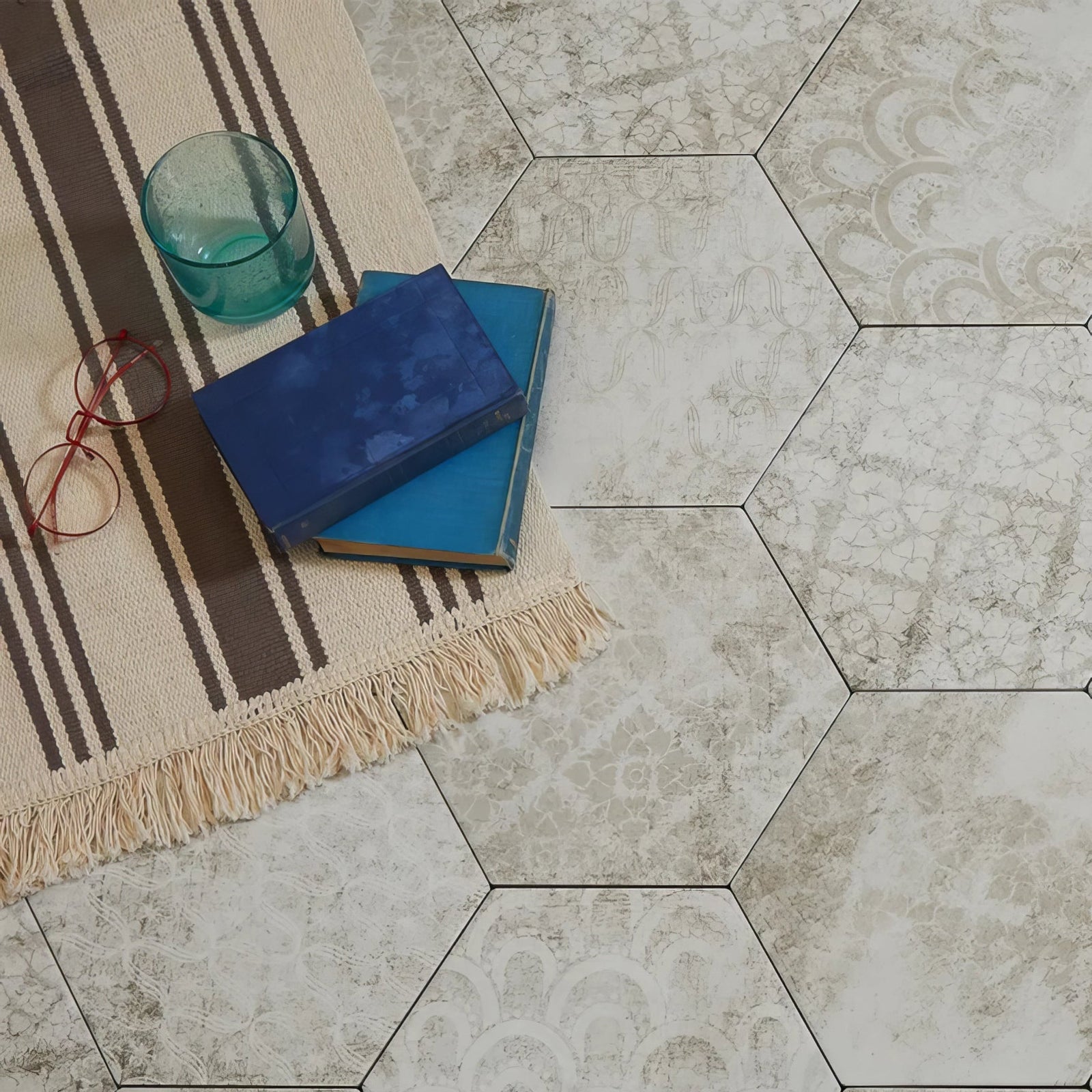 Hexagonal porcelain floor tiles with a subtle distressed white and gray pattern architectural elements melange