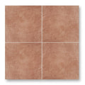Four square terracotta effect tiles with a textured matte finish arranged in a grid for indoor wall or floor use