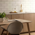 Arctic Clear Glass 300 x 100mm clear glass tile panel with a gold-toned tap