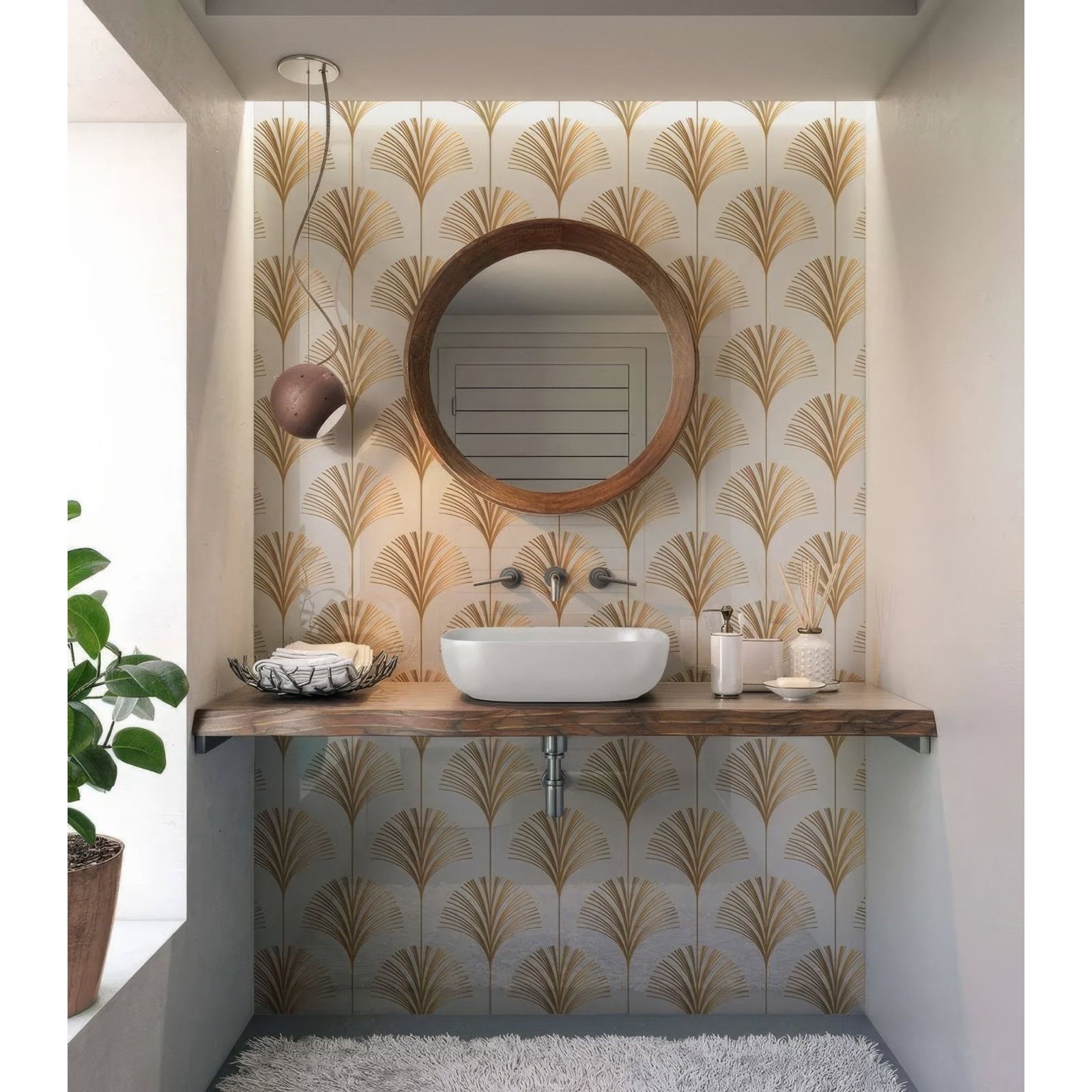 Round wooden-framed mirror with natural finish against gold leaf patterned wallpaper in art deco palm martini shower panel setting