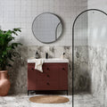 Rust-colored vanity with black round knobs and white arte italiano blanco porcelain countertop