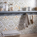 Arts & crafts flora blue 60x30cm botanical wallpaper features green leaves with yellow and purple flowers on off-white background