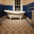 Arundel Dover white clawfoot bathtub with ornate feet and chrome fixtures in grey and pugin blue accents