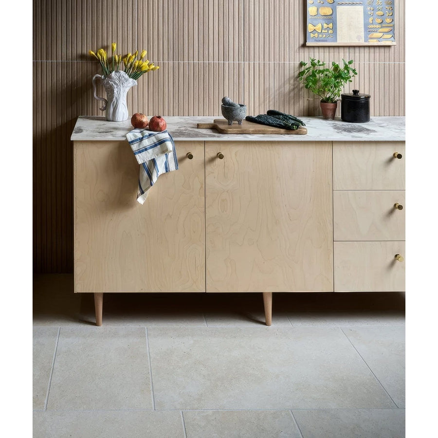 Light wood sideboard with marble countertop and brass handles featuring ascoli porcelain avorio 40 x 60cm tiles