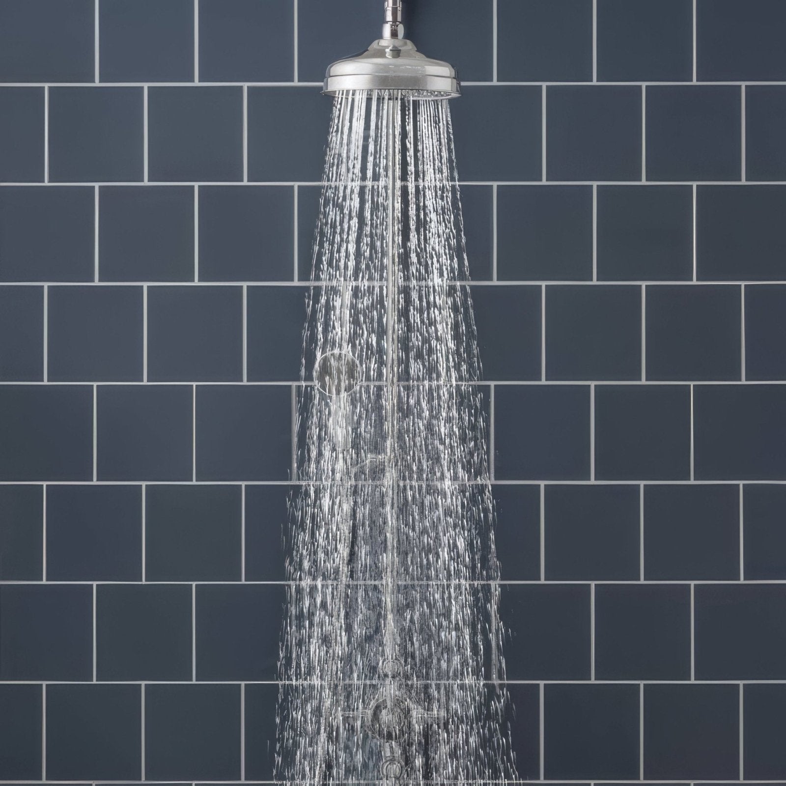 Showerhead with sleek polished chrome finish and multiple water jets dispersing wide spray for ascot blue field tile