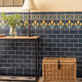 Dark blue ascot blue half tile subway wall with decorative yellow and green tulip border design