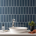 White ceramic vessel sink with a sleek rounded bowl shape featured in the ascot blue large brick collection