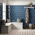 White l-shaped bench with wooden frame and upholstered seat with patterned pillows in ascot blue skirting tile setting