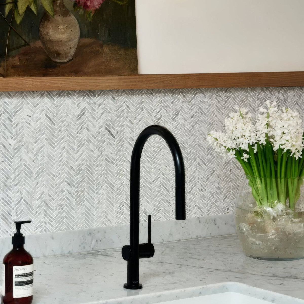 Athens Carrara Marble Mosaic white marble herringbone mosaic behind a black single-handle tap