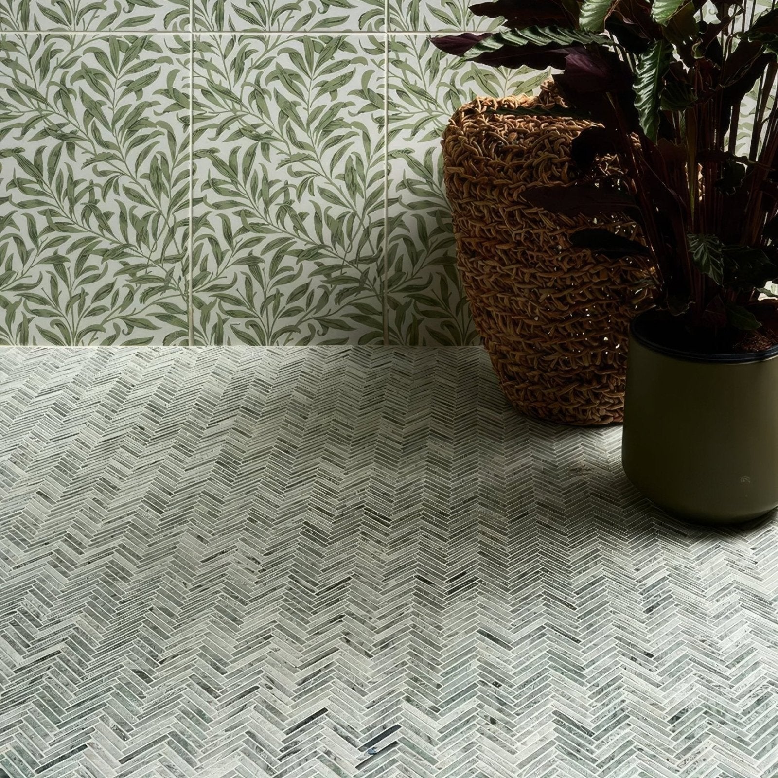 A herringbone-patterned athens mint marble mosaic countertop with light gray and dark charcoal tiles